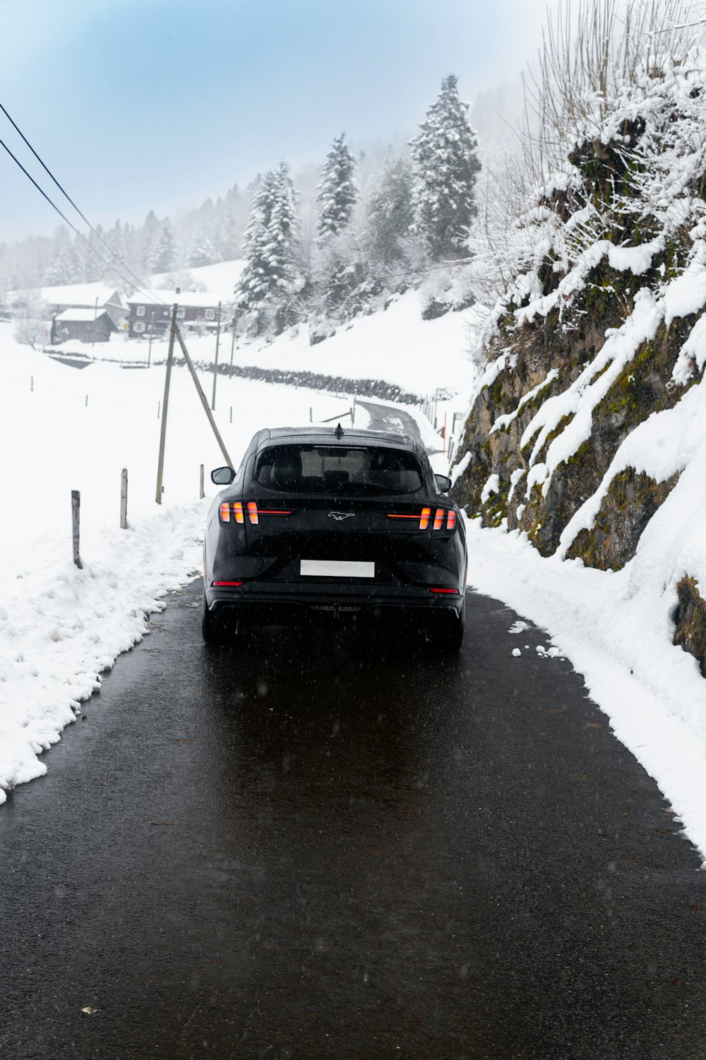 a car is driving down a snowy road