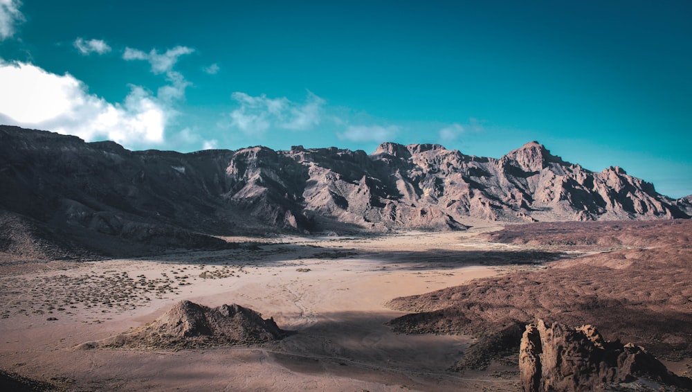 a desert landscape with mountains in the background