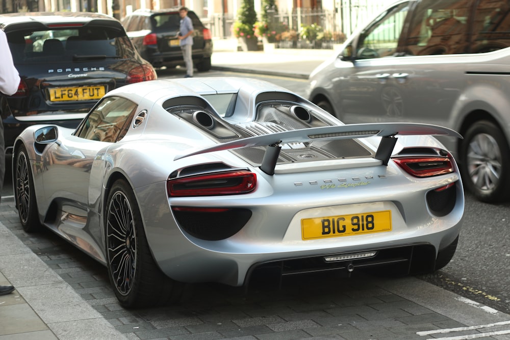 a silver sports car parked on the side of the road