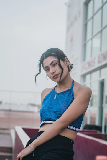 A young model confidently wearing the light blue and black harlox streetwear set in an urban setting.