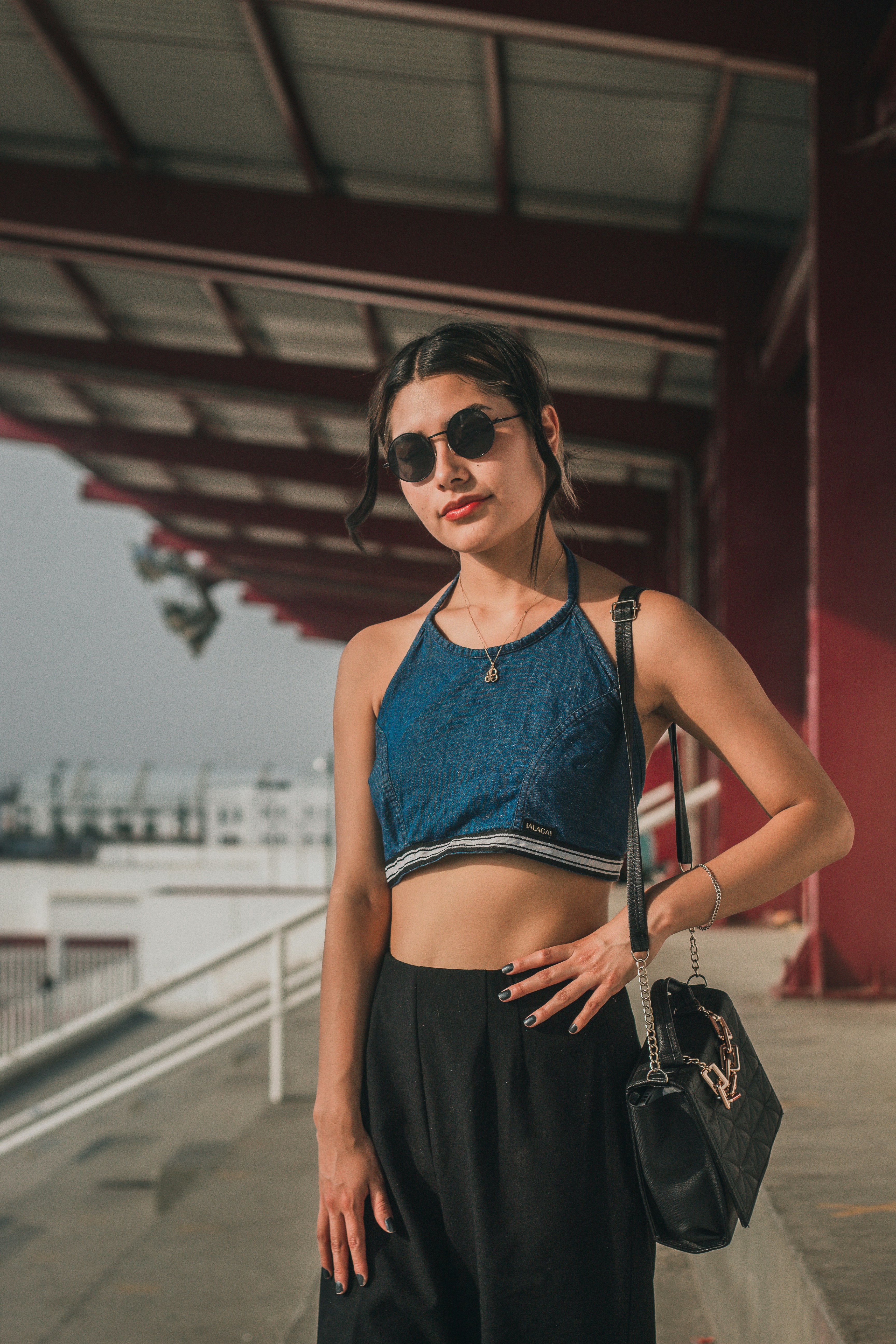 a woman standing in front of a building with her hand on her hip