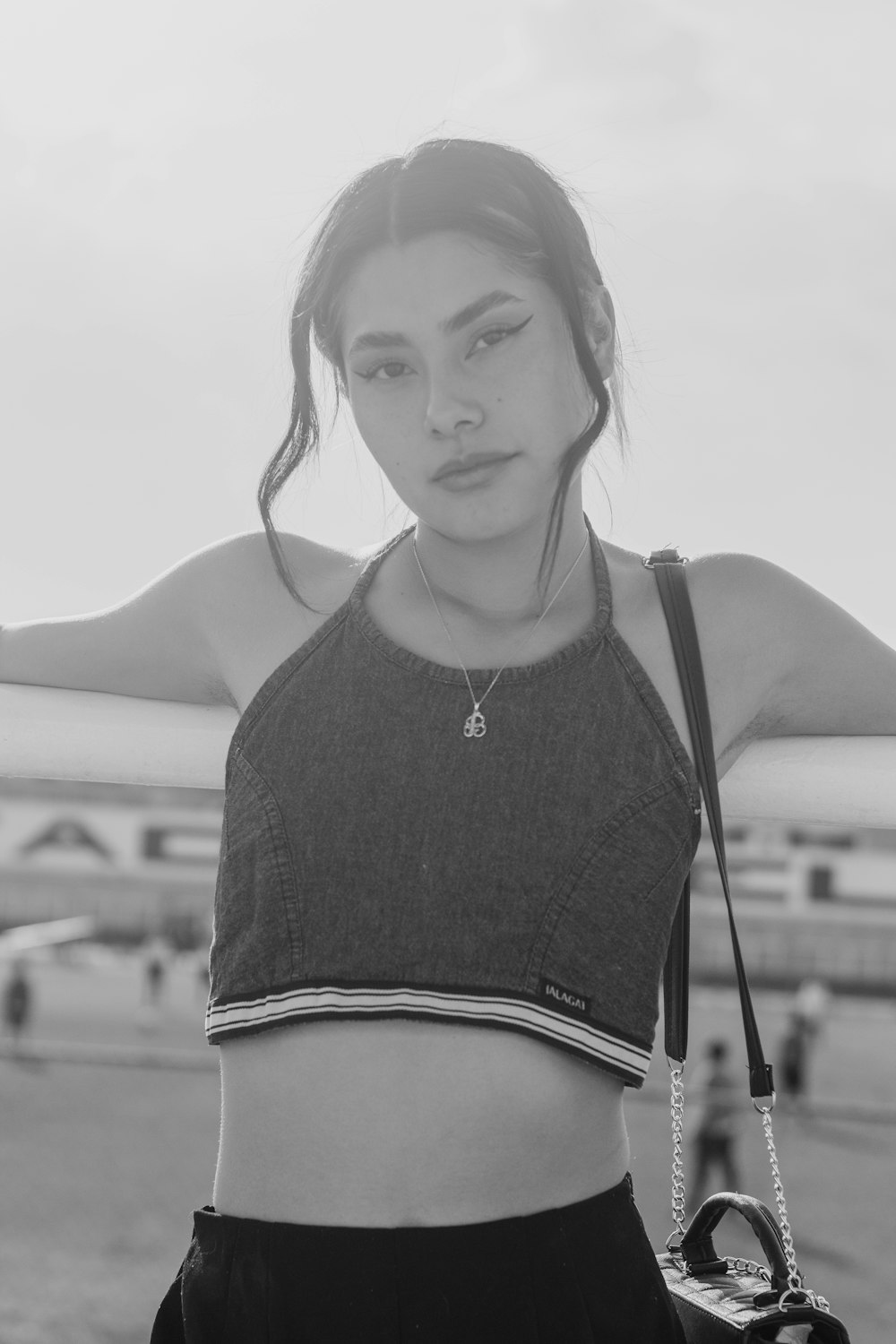 a woman in a crop top holding a camera