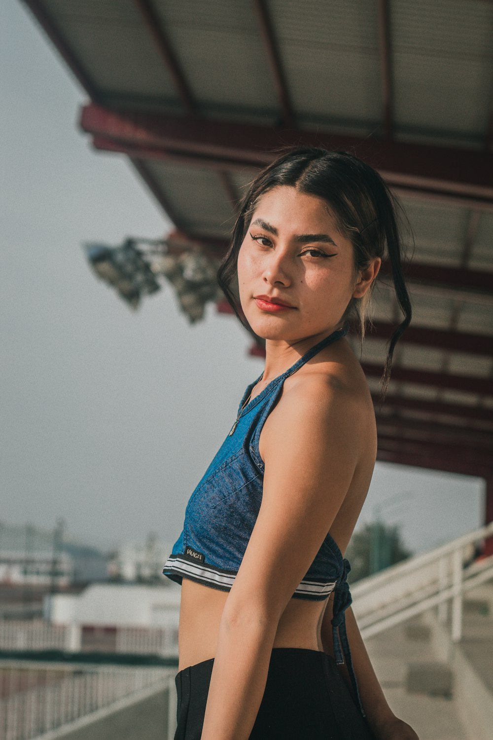 a woman in a blue top and black shorts