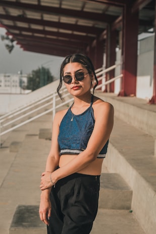 Model sitting on urban steps, showcasing Lumina Apparel’s breathable, activewear pants in natural light.