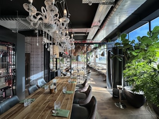 a dining room with a wooden table and a chandelier