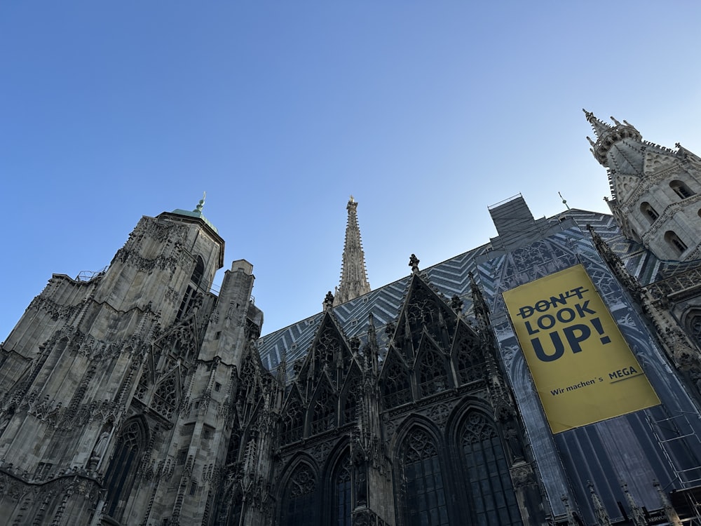 a very tall cathedral with a sign in front of it