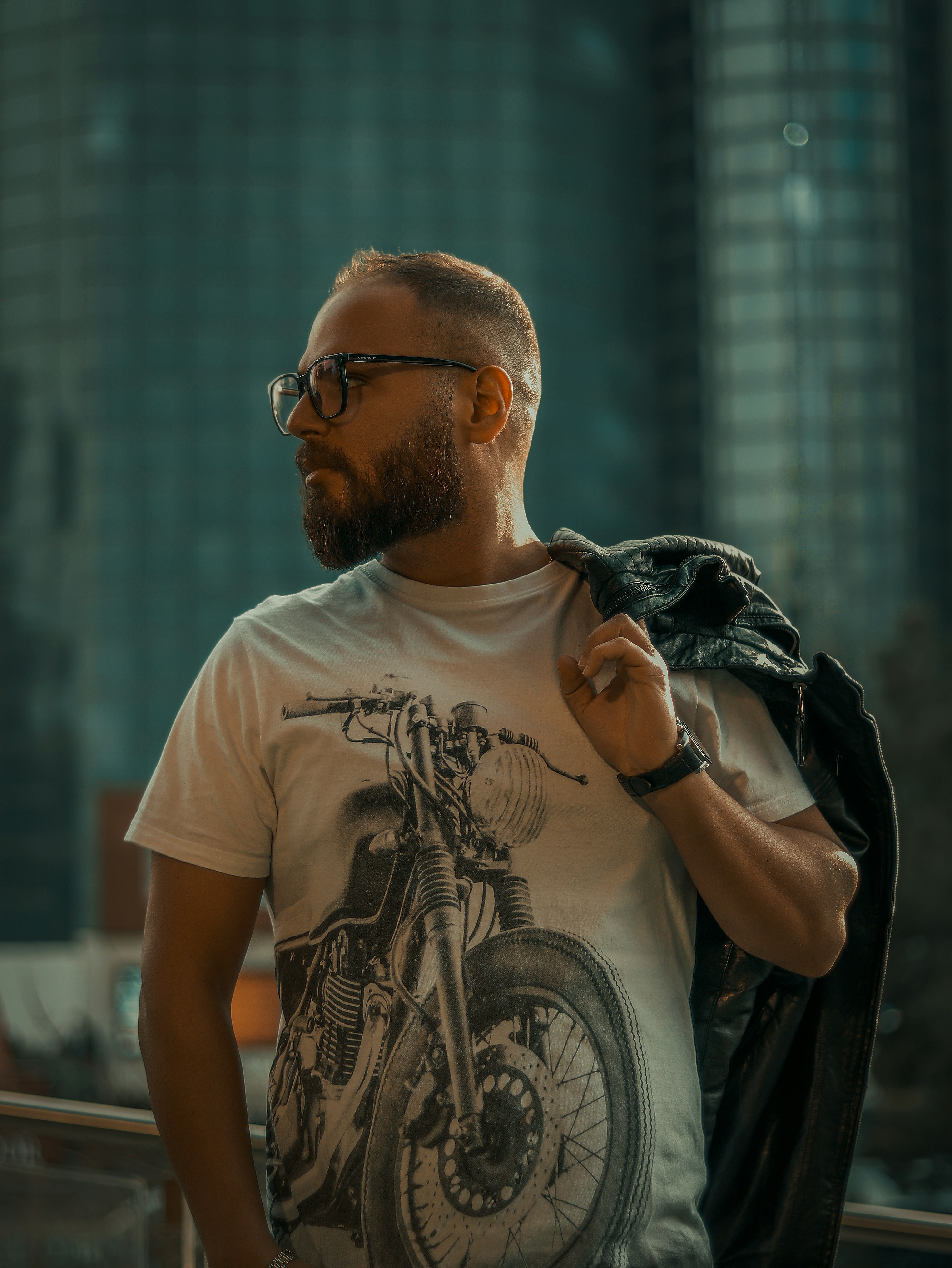 a man with a beard wearing a motorcycle t - shirt