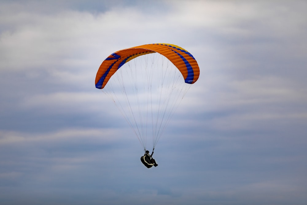 a person is parasailing on a cloudy day