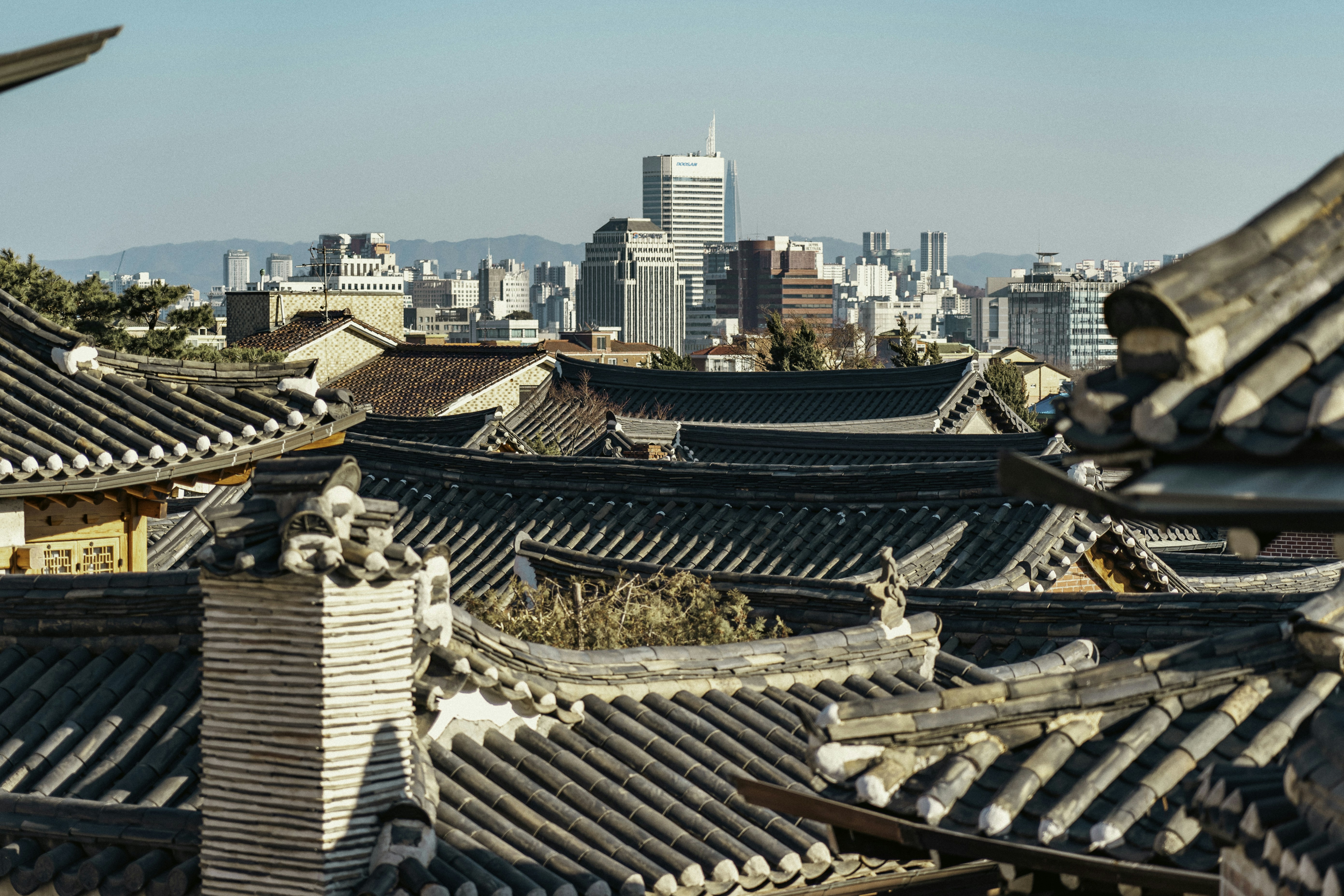 a view of a city from a roof top, The Evolution of Seoul: From Traditional Village to Modern Metropolis