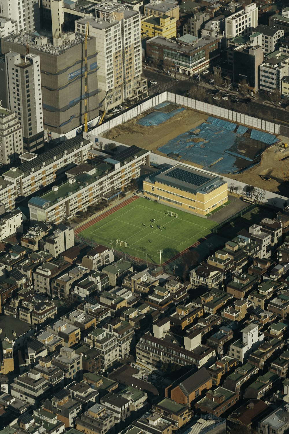 an aerial view of a soccer field in a city