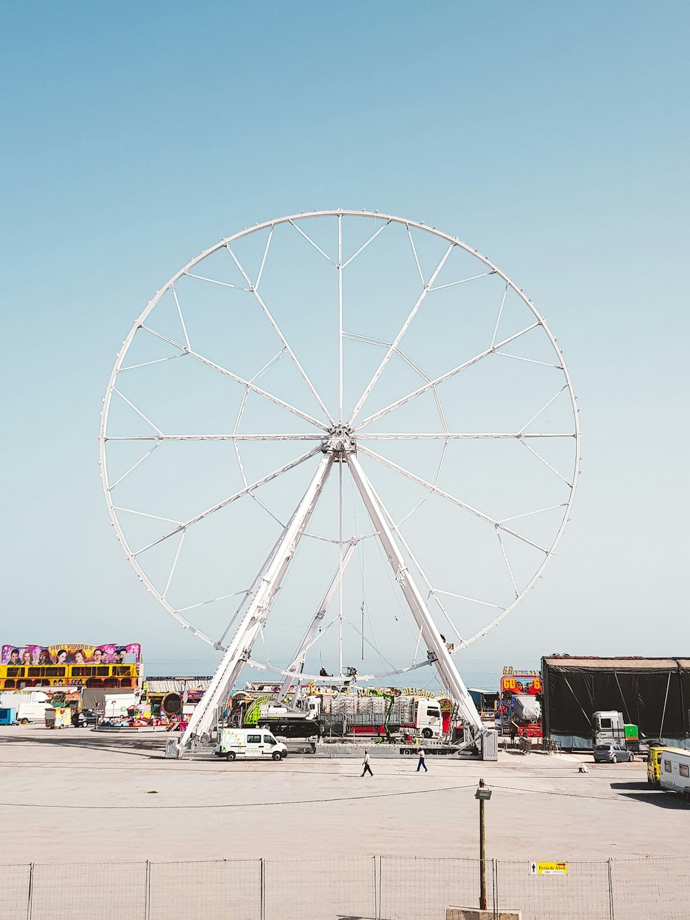 a large white ferris wheel sitting on top of a parking lot