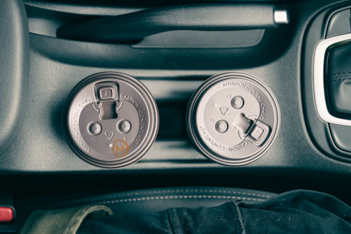 Small car accessories arranged neatly inside a car cup holder