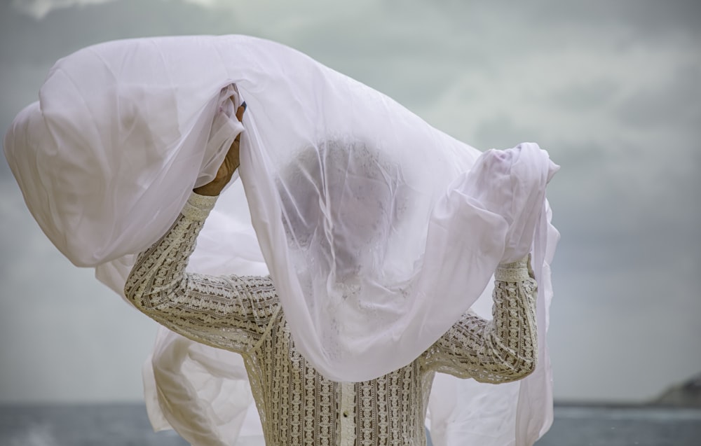 a man with a white cloth covering his face