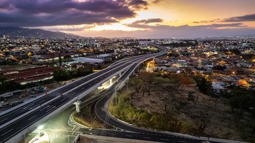 Sunset view of a completed highway with street lighting.