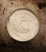 Close-up of rich, creamy shea butter in a rustic wooden bowl.