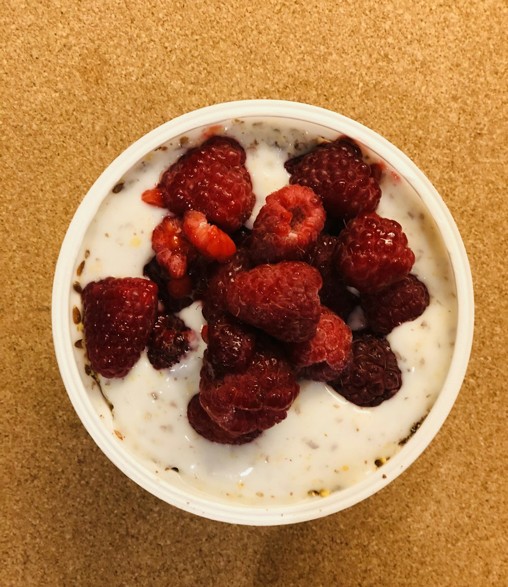 a bowl of yogurt with raspberries on top