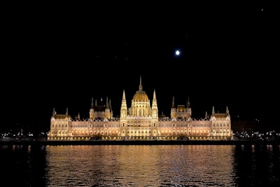 Evening shot of shahrukhz’s illuminated facade reflecting on the calm waters of the seafront.