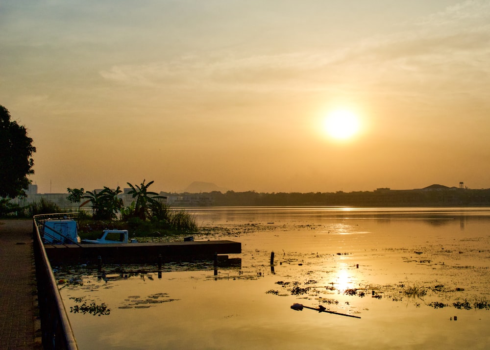 the sun is setting over a body of water