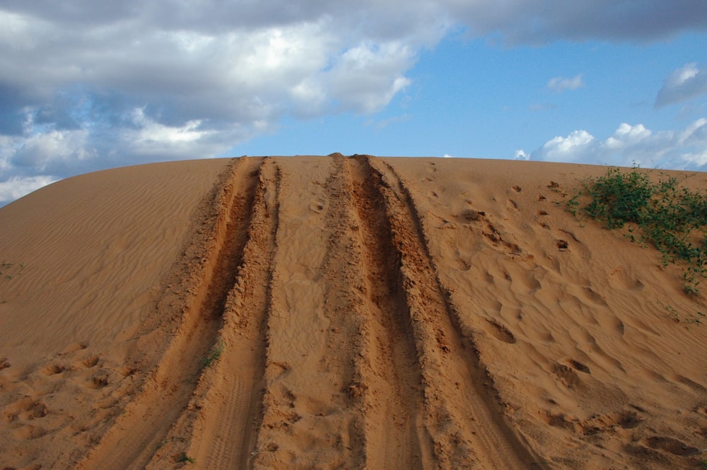 a dirt road in the middle of a desert