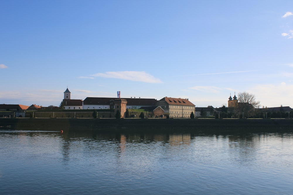 a large body of water with buildings in the background