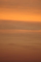 Abstract horizon line ascending with warm orange and cool blue tones.
