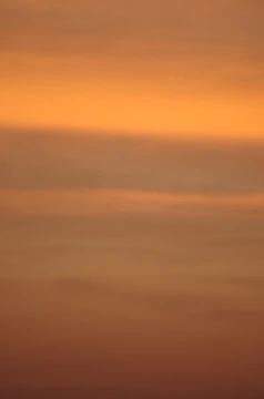 Abstract horizon line ascending with warm orange and cool blue tones.