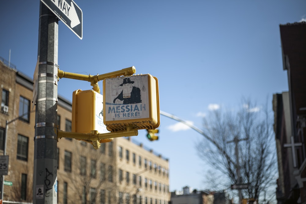 a yellow traffic light sitting on the side of a road