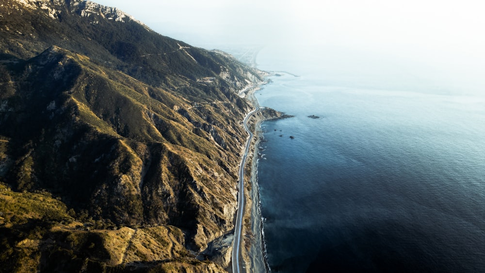 an aerial view of a road on the side of a mountain