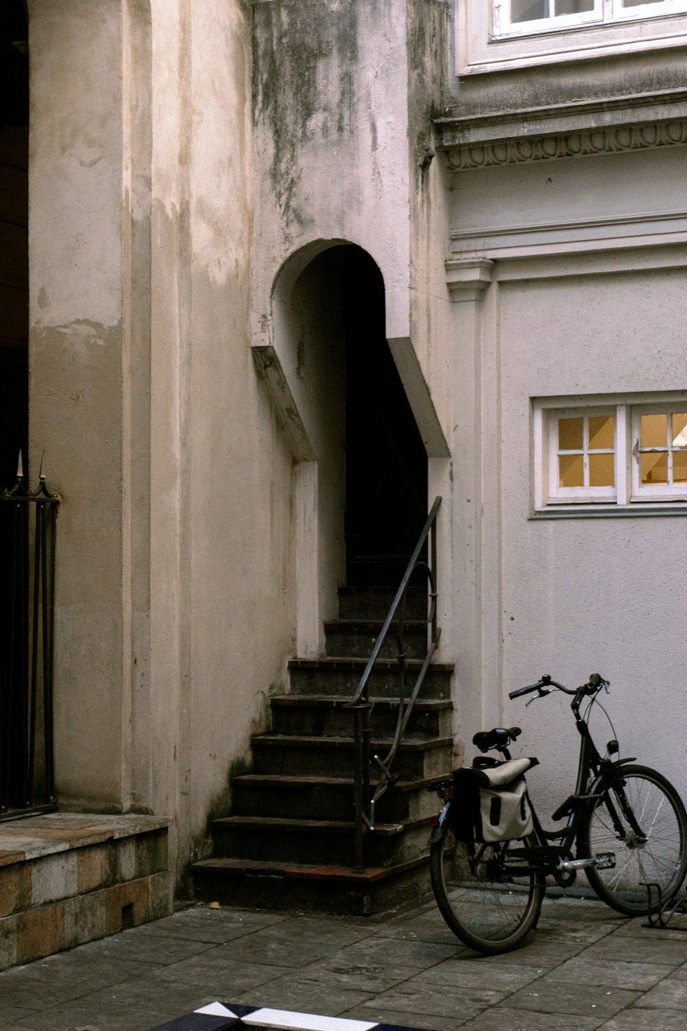 a bicycle is parked next to a building