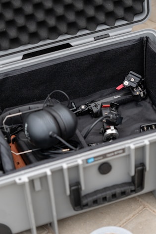 a case filled with electronic equipment on a tile floor