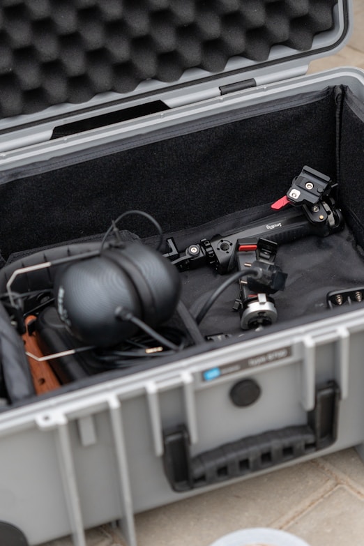a case filled with electronic equipment on a tile floor