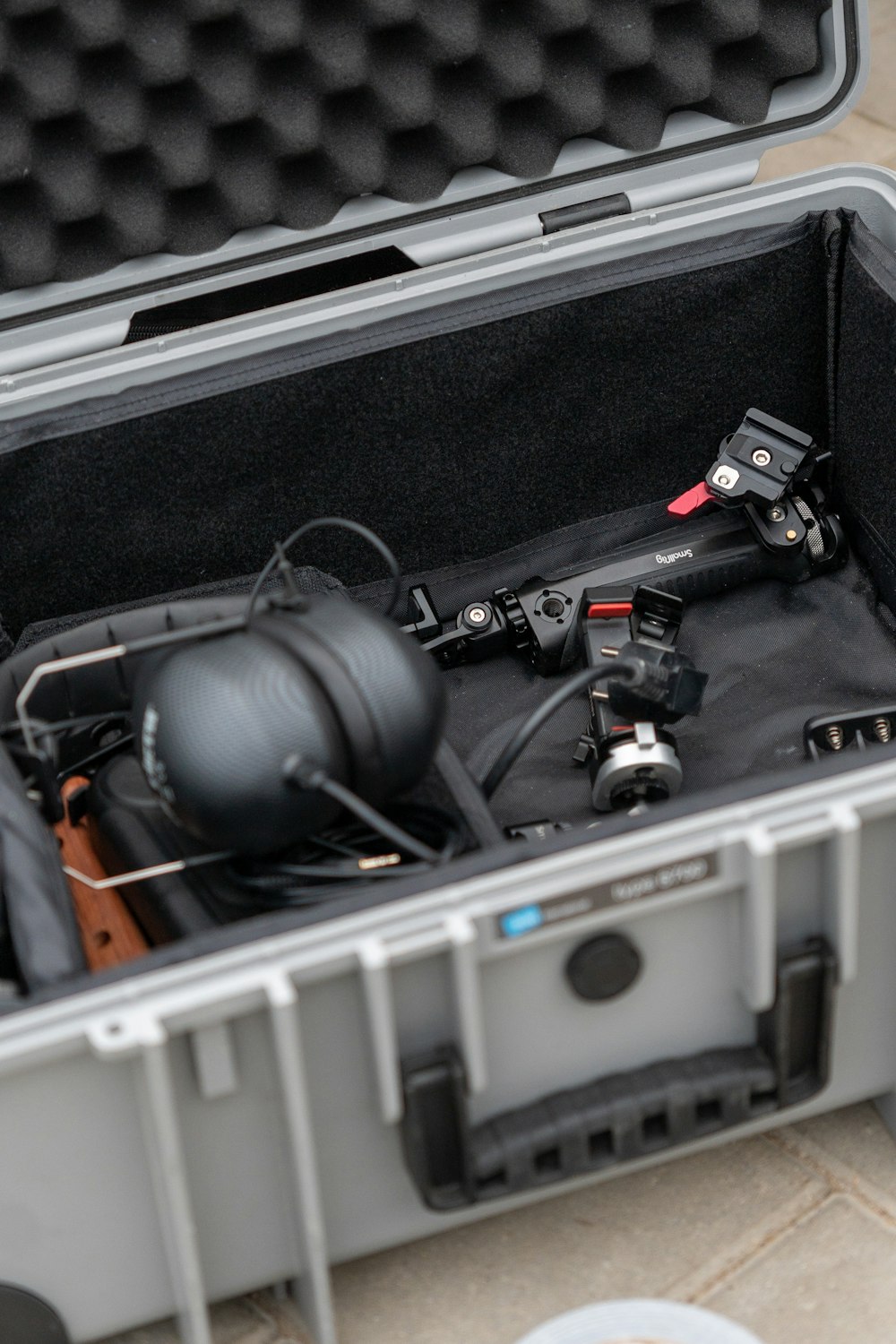 a case filled with electronic equipment on a tile floor