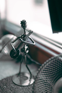 a metal object sitting on top of a table next to a window