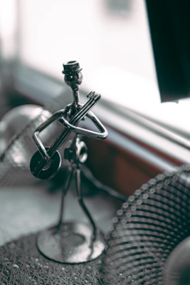 a metal object sitting on top of a table next to a window