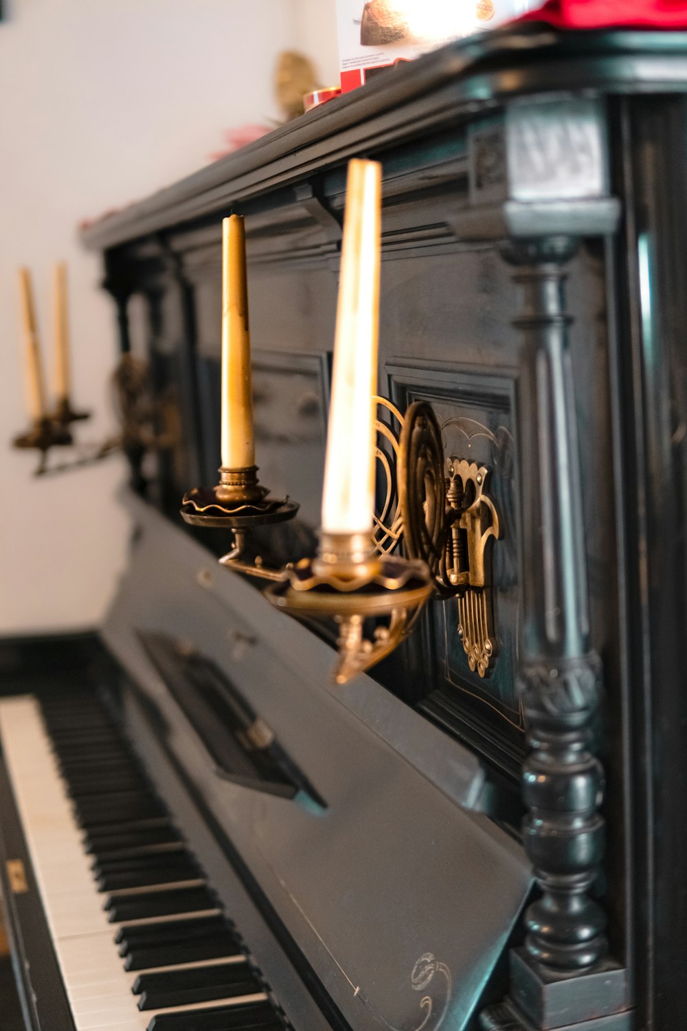 a piano with two candles on top of it