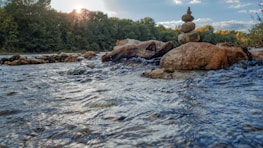 rocks stacked on top of each other in the middle of a river