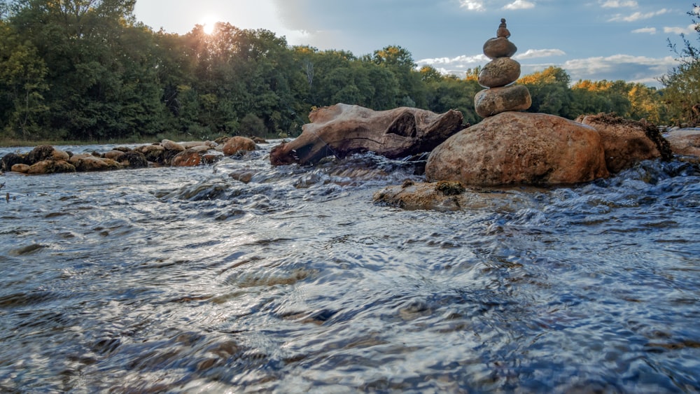 rocks stacked on top of each other in the middle of a river