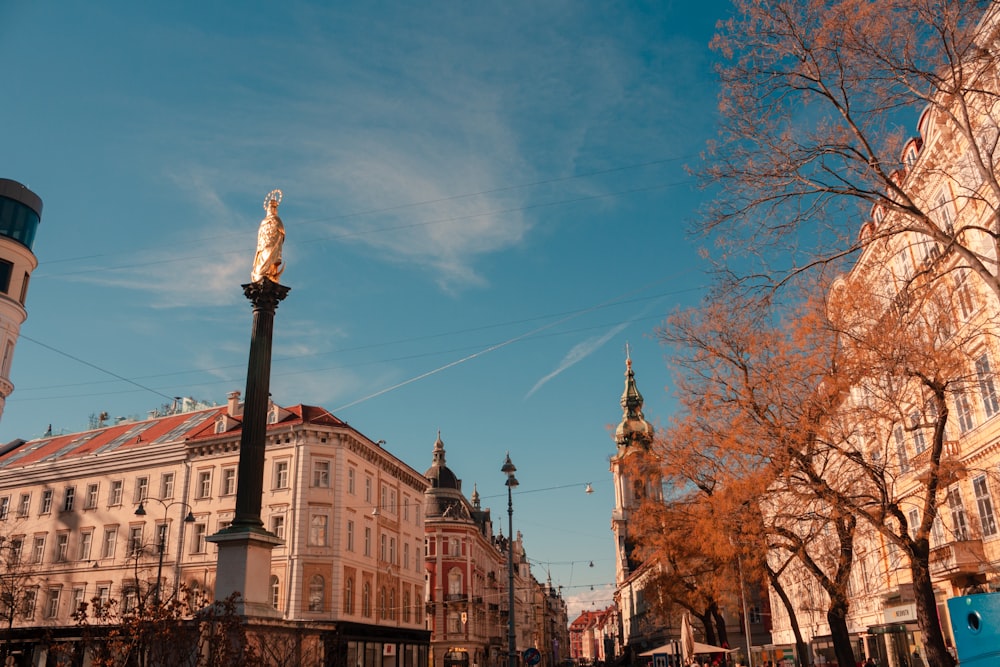 a city street with tall buildings and a clock tower