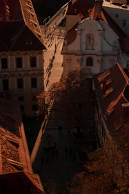 An elegant shot of a terracotta-colored street in a quaint European village bathed in golden hour light.