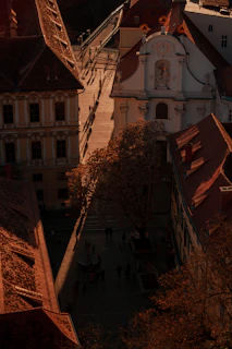 An elegant shot of a terracotta-colored street in a quaint European village bathed in golden hour light.