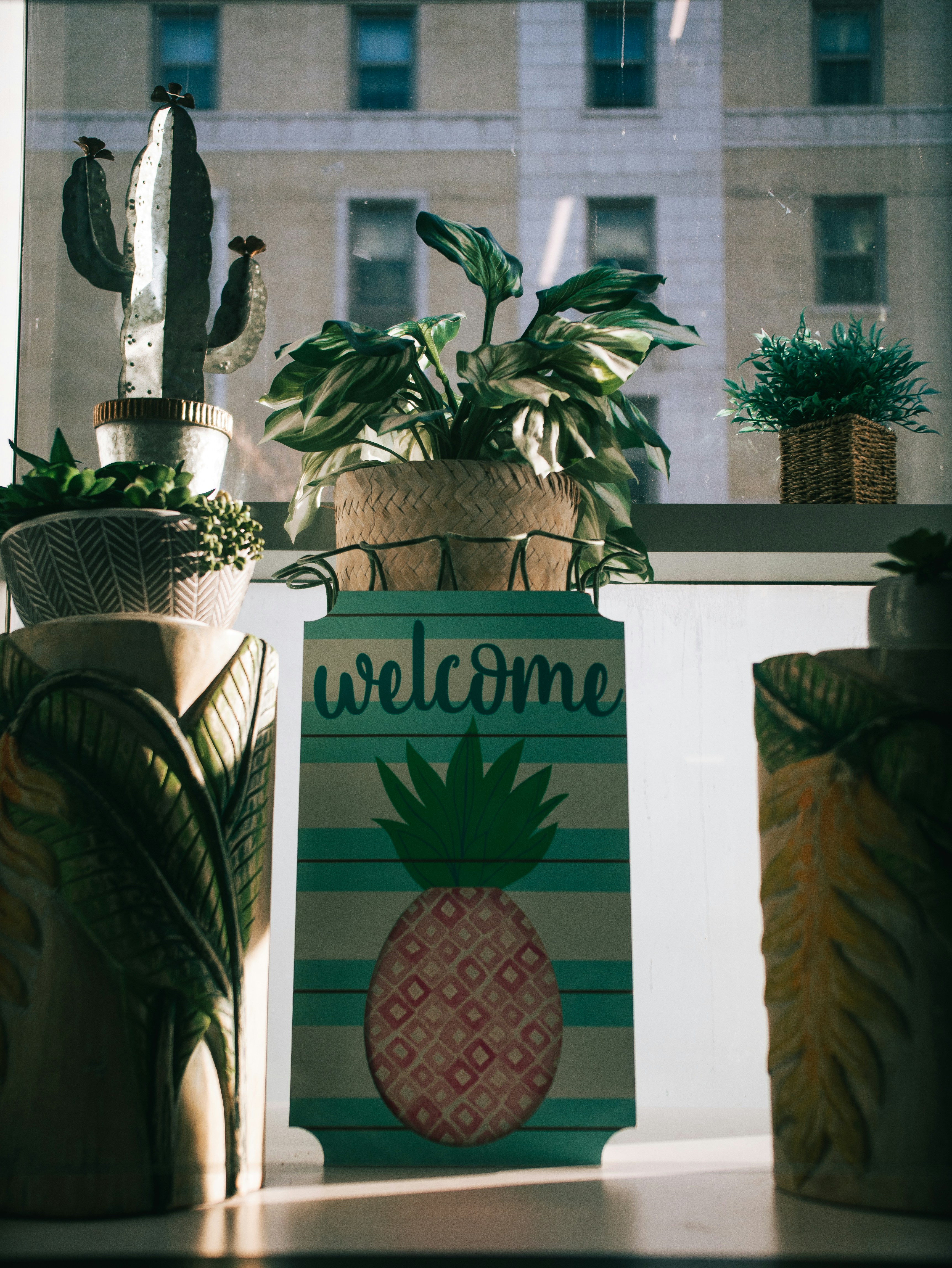 a welcome sign sitting on top of a window sill