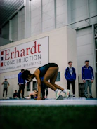 Close-up of a sprinter exploding off the starting blocks on a track.