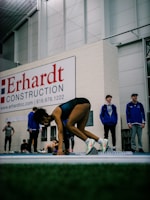 Athlete undergoing a sprint test on a professional track with mvp staff monitoring performance