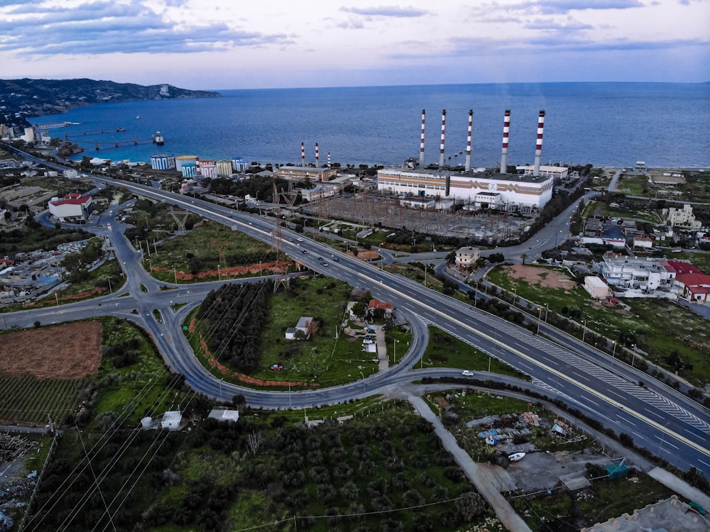 an aerial view of a highway near a body of water