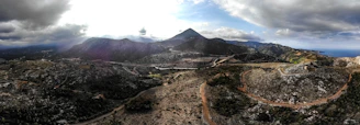 A panoramic shot of the rugged Cilaos cirque with winding roads and mountain peaks.