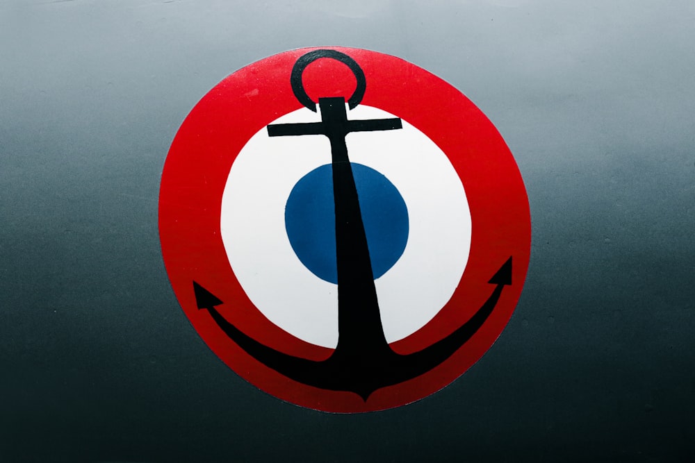 a red, white and blue sign with an anchor on it