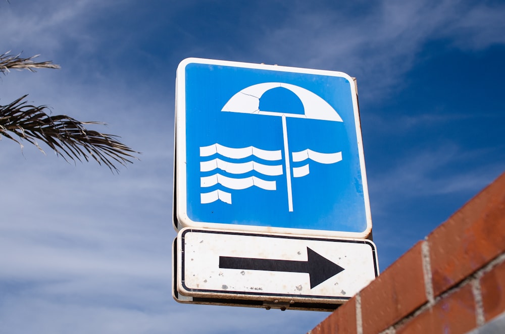 a blue street sign with an arrow pointing to the right