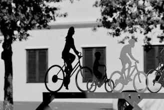 a black and white photo of people riding bikes