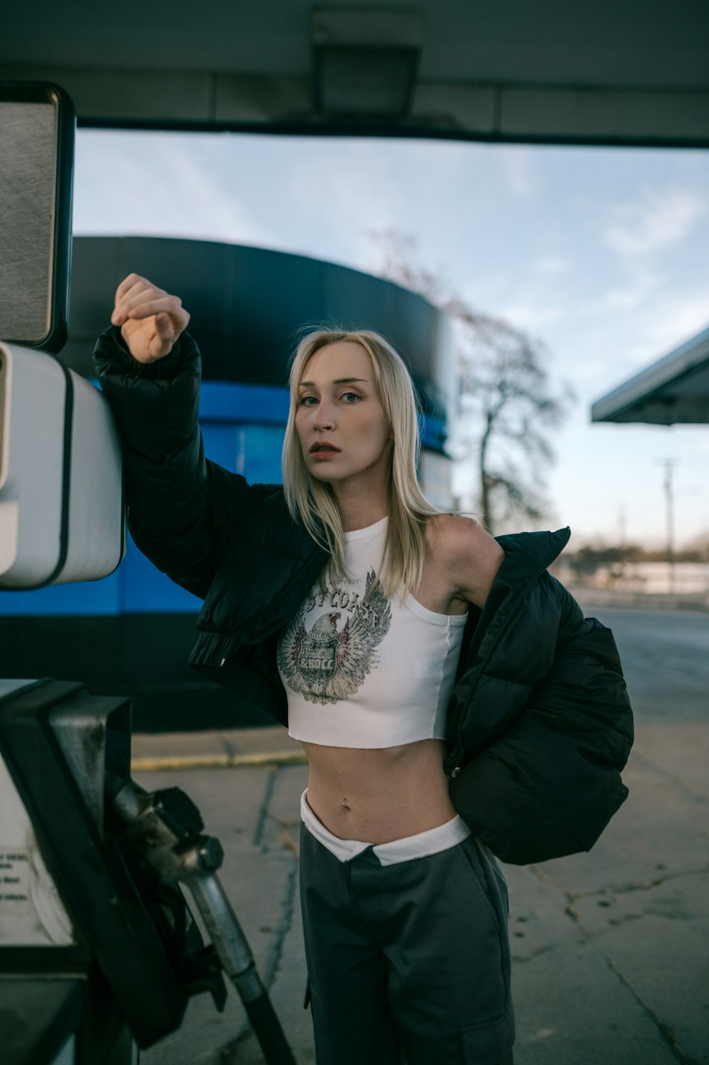 a woman standing next to a blue and white truck