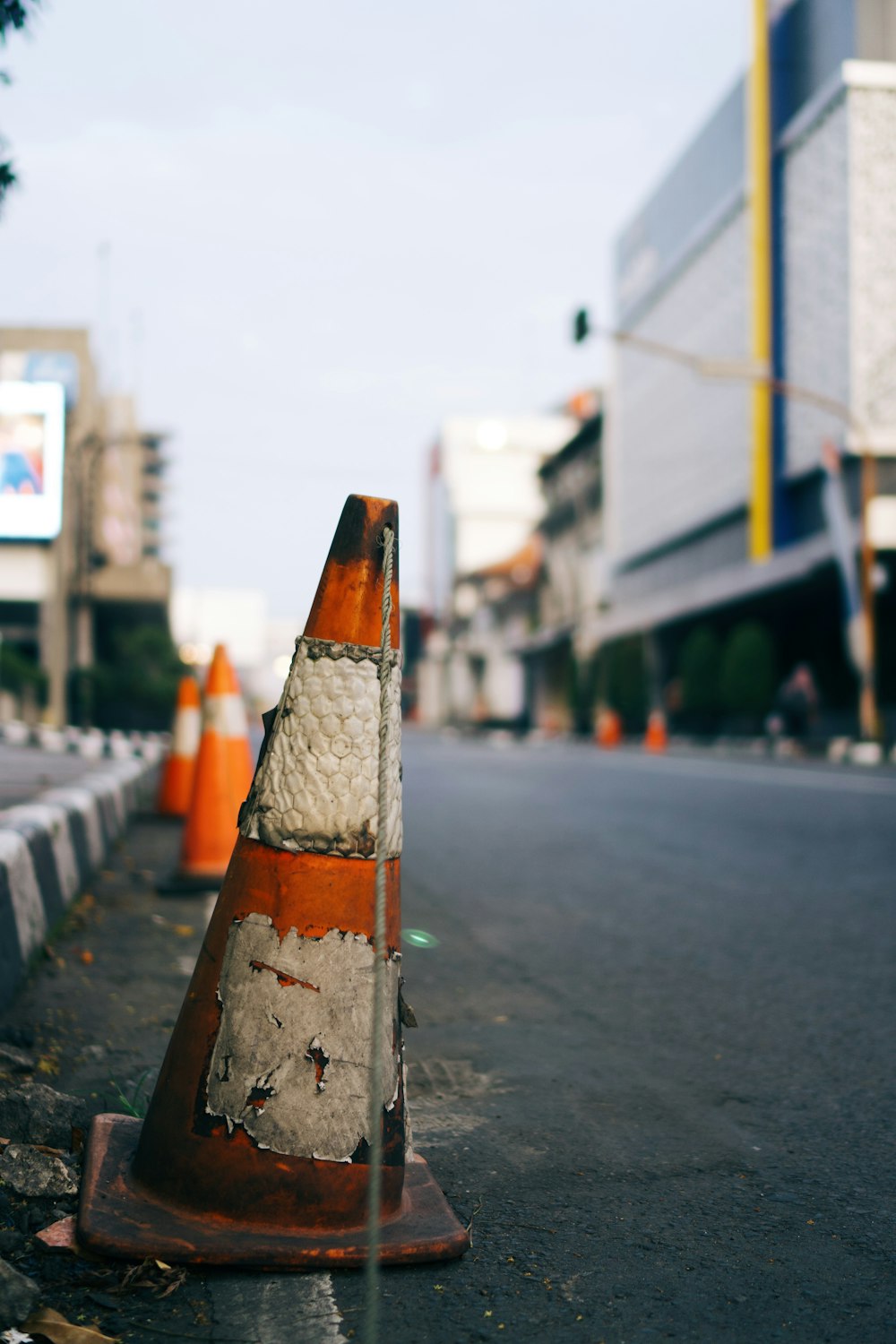 a traffic cone sitting on the side of a road